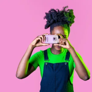 myFirst Camera 50 lila barnkamera som hålls av ett barn och visar den kompakta designen och den främre linsen